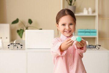 Cute little girl with contact lenses in clinic