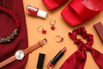Composition with jacket, cosmetics and accessories on orange background. Closeup