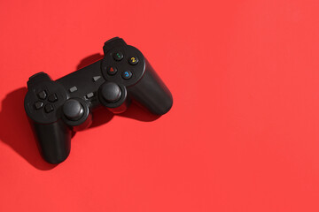 Modern game pad on red background