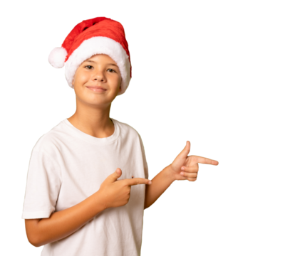 Smiling child boy wearing a santa Claus hat pointing fingers side over transparent background. PNG.