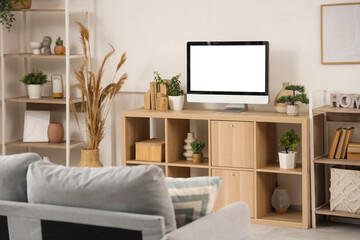 Blank TV monitor with plants on stand in living room