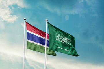 The Gambia Saudi Arabia friendship flags are waving in the sky. Two country flag for agreement or deal. The Gambia KSA national flag for commitment.