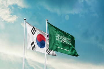 South Korea Saudi Arabia friendship flags are waving in the sky. Two country flag for agreement or...