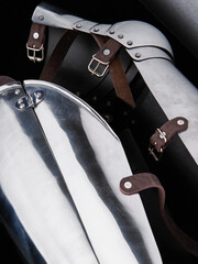 Detailed close-up of polished medieval armor pieces showing craftsmanship, with metal plates and...