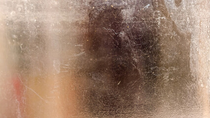 An abstract textured look through the dusty glass dirt, revealing faded colors and blurred...