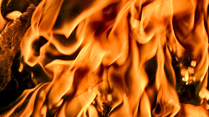 Fiery orange and yellow flames dance and swirl, creating a mesmerizing texture of burning embers.