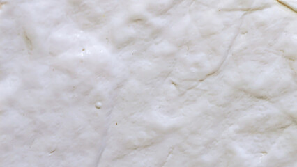 Close-up texture of white wall paper showing wrinkles and subtle color changes