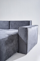 Gray upholstered sofa showcased in a bright environment, emphasizing elegance, comfort, and modern...