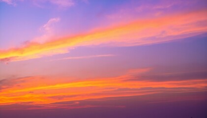 Fototapeta premium A vibrant sunset sky painted with hues of orange, pink, and purple, scattered clouds reflecting the warm colors, creating a breathtaking evening scene.
