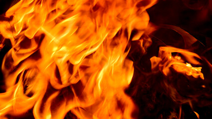 Intense flames burning, creating a dynamic and fiery abstract pattern against a dark background.