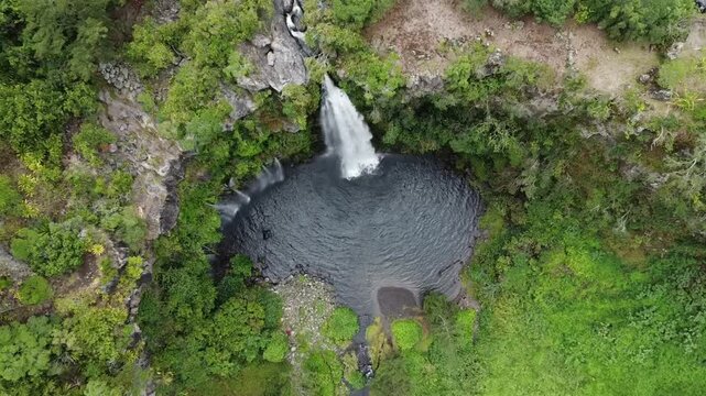 Aerial footage of a drone flying down towards the grand bassin in la plaine des cafres in La Reunion island.