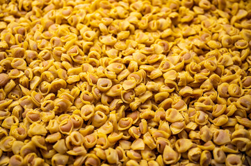 Fresh tortelloni pasta sold in a grocery in the city of Bologna in Italy. © Giannis