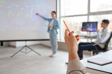 Fototapeta premium Hand of male trader with pencil during presentation in office, closeup