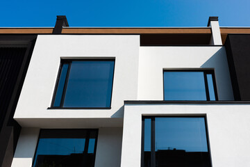 Modern architecture featuring a white building with bold geometric shapes and blue sky.