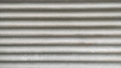 Fragment of old roof with wavy asbestos cement roof tile, Full frame shot of patterned textile.Frozen roof with moss and leaves