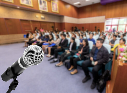 Microphone voice speaker with audiences or students in seminar classroom, lecture hall or conference meeting in educational business event for host, teacher, or coaching mentor.