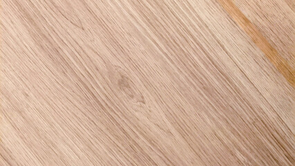 Close-up of a light brown wooden surface with natural grain patterns and subtle color variations.