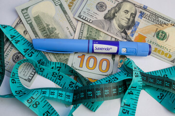 Basra, Iraq - August 5, 2025: Saxenda Pen and Money for Weight Loss and Healthcare Expense