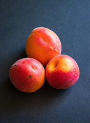 Apricots are on the dark background. Fresh fruits. 