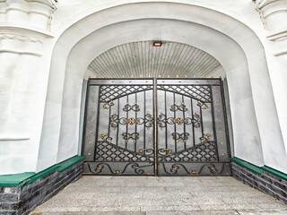 Elaborately designed decorative gates stand majestically at the entrance of a historic building,...