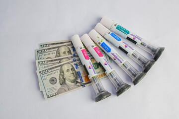 Basra, Iraq - August 5, 2025: Mounjaro Pens and Money Representing High Cost of Medicin