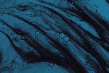 Dark blue abstract liquid with small air bubbles. Macro of deep blue fluid with floating bubbles...