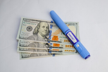 Basra, Iraq - August 5, 2025: A Saxenda Pen Resting on a Stack of American One Hundred Dolla