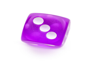 Purple game dice on white background