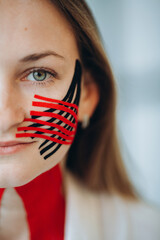 Young woman with kinesio taping on face for pain relief
