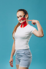 Young woman showing kinesio taping on face and neck