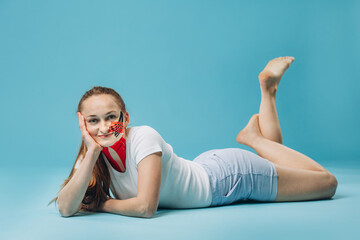 Obraz premium Young woman lying down with kinesio tape on face and neck