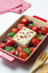 Baked feta cheese with tomatoes and olives. Healthy food. Vegetarian food.