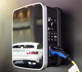 Electric car charging on parking lot with electric car charging station on city street. Close up of...