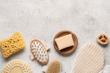 Composition with massage body brushes, massage glove, sponge and soap bar on white grunge background, closeup
