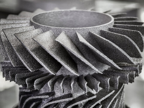 3D printed turbine component showcasing intricate details and precision in design at a modern manufacturing facility