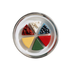 A vibrant assortment of colored food segments displayed on a round plate, featuring various textures and fresh ingredients, perfect for healthy eating inspiration.