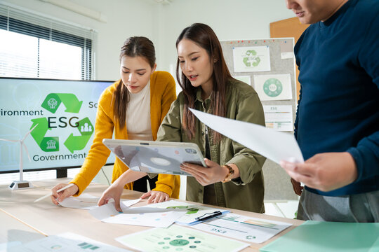 Asian business team discussion reusable product in office,start up eco-friendly business,environmental protection,sustainable business model,ESG strategy,team meeting,people work at home concept