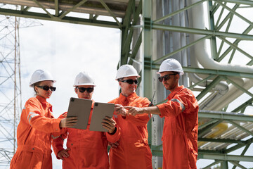 Petroleum Refinery. Oil refinery. Group of petrochemical engineer discussing, working by digital...
