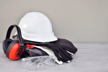 Protective white helmet, special uniform, headphones, gloves and glasses. Standard safety measures when performing construction work.
