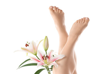 Feet of young woman with fresh pedicure and lily flowers isolated on white background, closeup