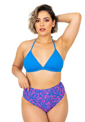 Fototapeta premium A beautiful curvy woman models a stylish two-piece swimsuit with a blue triangle top and floral high-waisted bottoms, Isolated on a Transparent Background PNG.