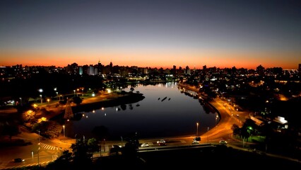 Fototapeta premium Dam Park In Sao Jose Do Rio Preto Sao Paulo Brazil. Famous Botanical Garden Showing The Around The City. Sunset Clouds Sky Downtown. Sunset Outdoors Downtown Panning Wide.