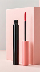 Obraz premium Black mascara tube with pink applicator brush next to a pink block