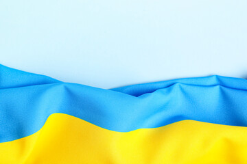 Flag of Ukraine on blue background, top view