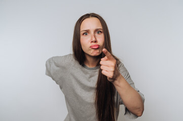 portrait of young woman conveys anger through a powerful hand gesture and intense expression on...