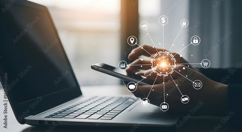 Poster hands using smartphone with laptop beside and a digital network overlay in a blurred background
