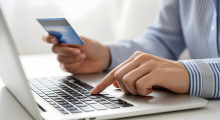 Hands Using Silver Laptop for Online Payment Holding Blue Credit Card on White Background