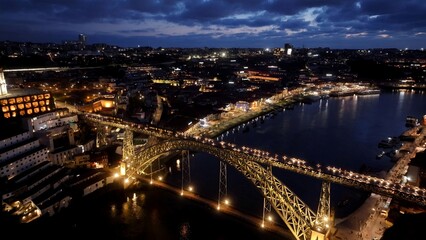 Fototapeta premium Night Dom Luis I Bridge In Porto Portugal. Scenic Railway Station And Skyscrapers From Above. Building Town Sky Background Illuminated Urban. Illuminated City Landmark. Porto Portugal.