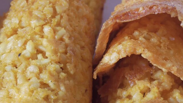 Slow pan of almond-based tejas with vibrant golden color and crispy surface