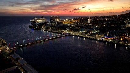 Fototapeta premium Sunset Curacao Skyline In Otrobanda Willemstad Curacao. Birds Eye View Of Stunning Cityscape With Streets And Buildings. Building Town Sky Clouds Illumination Urban. Exterior Famous.